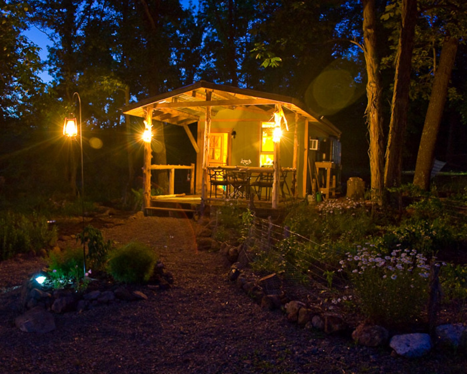 A tiny house lit at by lanterns night