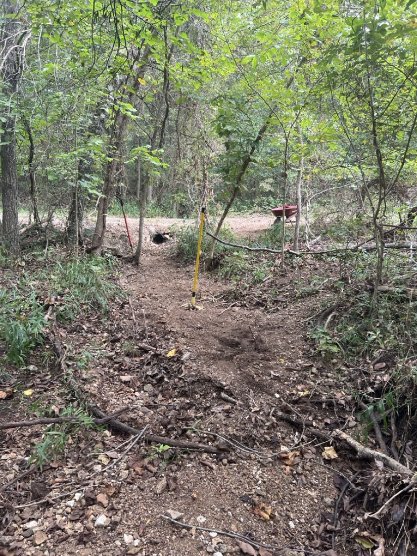 A photo of a creek bed that has been recently cleaned of debris